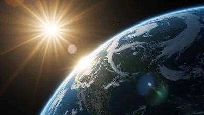 一张从太空拍摄的地球写实壁纸，带有大气层边缘的金色阳光。